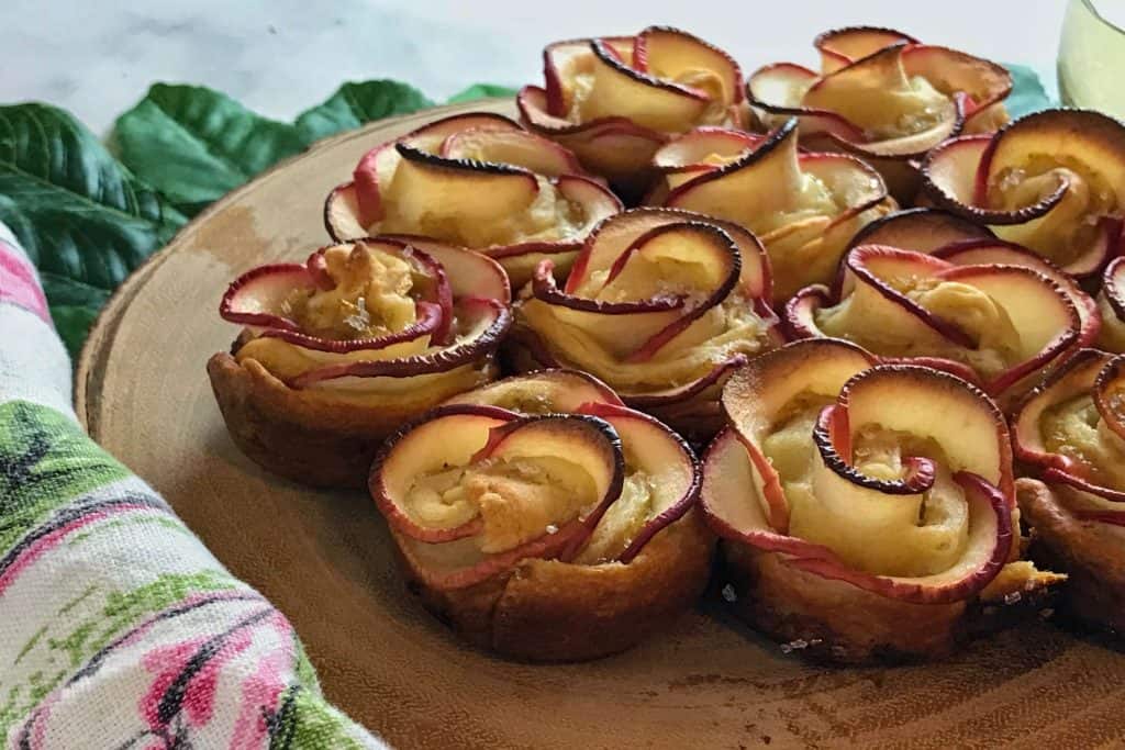 Who wouldn't love a dozen of these homemade Apple Roses? Simple, beautiful, delicious and filled with a white wine and spiced golden raisin puree.